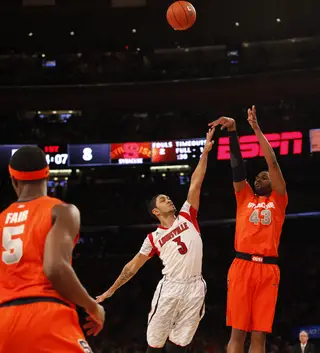James Southerland shoots a 3 over Peyton Siva. He broke Gerry McNamara's record for 3s in a Big East tournament.