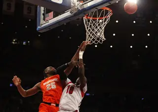 Rakeem Christmas goes for a defensive rebound in the paint against Louisville's Gorgui Dieng (#10).